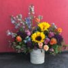 Colorful custom flower arrangement sitting on a table.