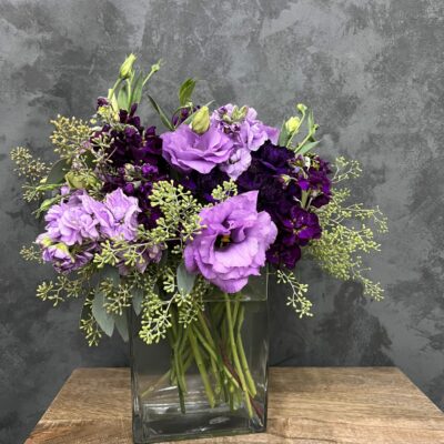 Purple flower arrangement in a glass vase.