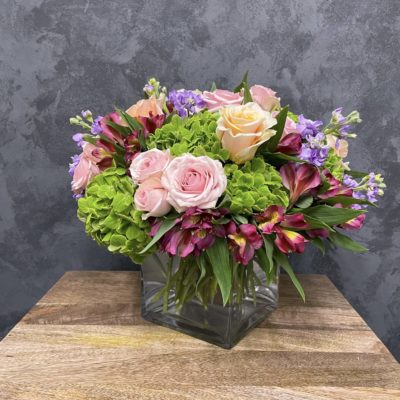 mothers day flower arrangement with a beautiful, classy arrangement of roses, hydrangeas and lilacs are presented in a glass vase and delivered with love.