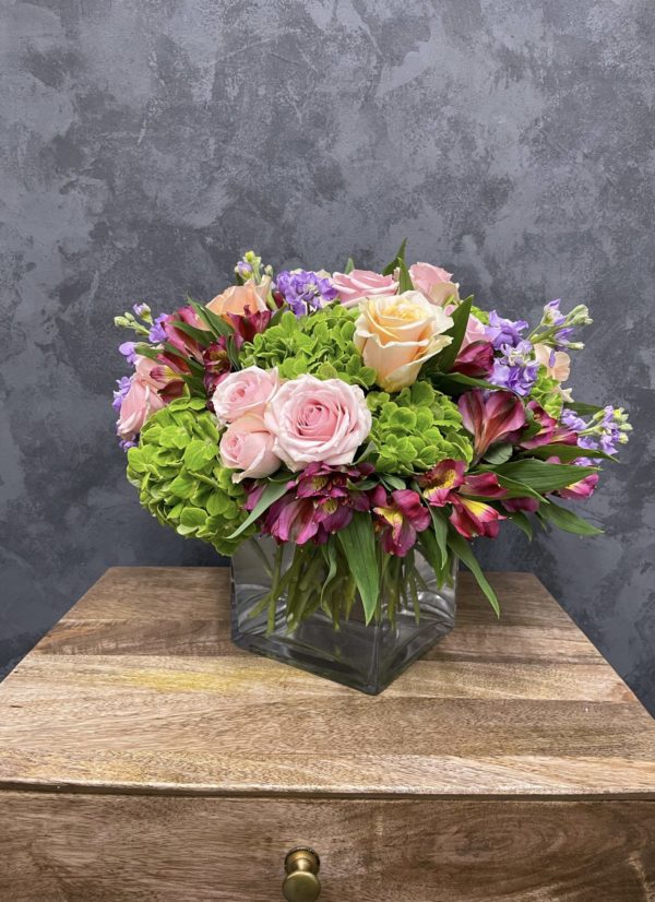 mothers day flower arrangement with a beautiful, classy arrangement of roses, hydrangeas and lilacs are presented in a glass vase and delivered with love.