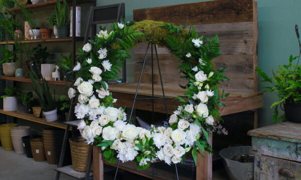 funeral wreath of white flowers on a stand