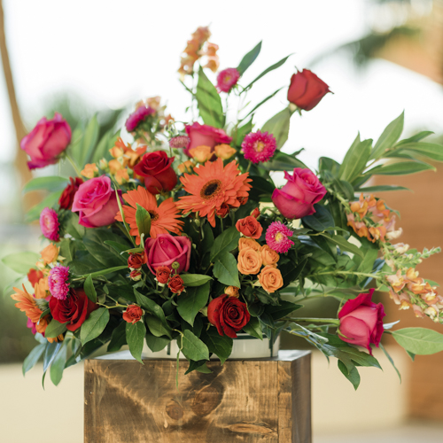 Wedding centerpiece in reds, oranges and greens