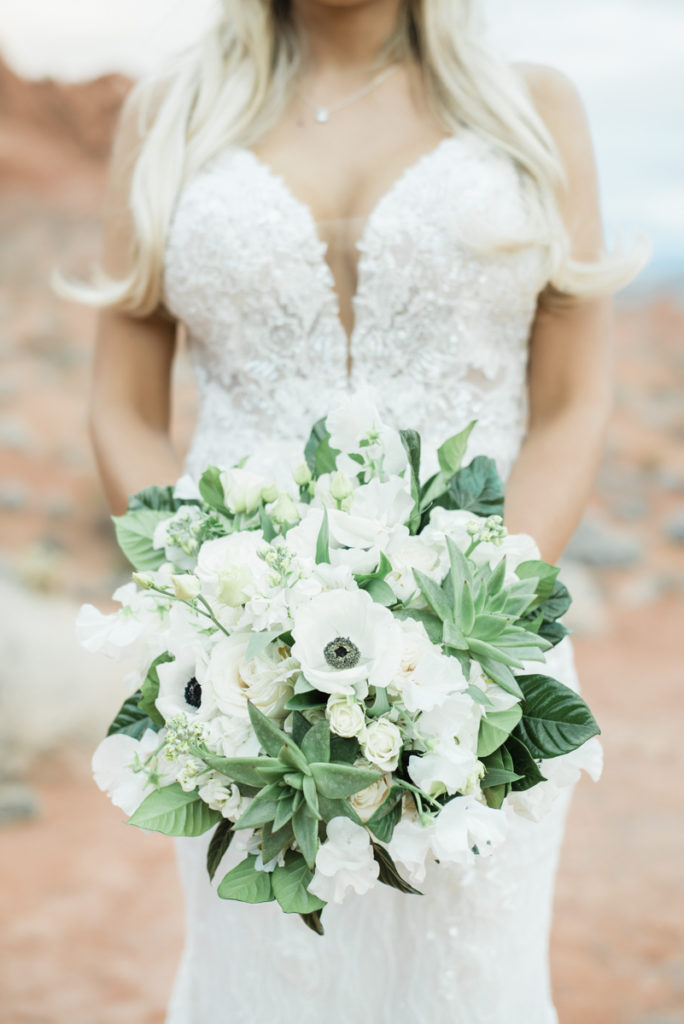 Bride holding a white wedding bouquet.