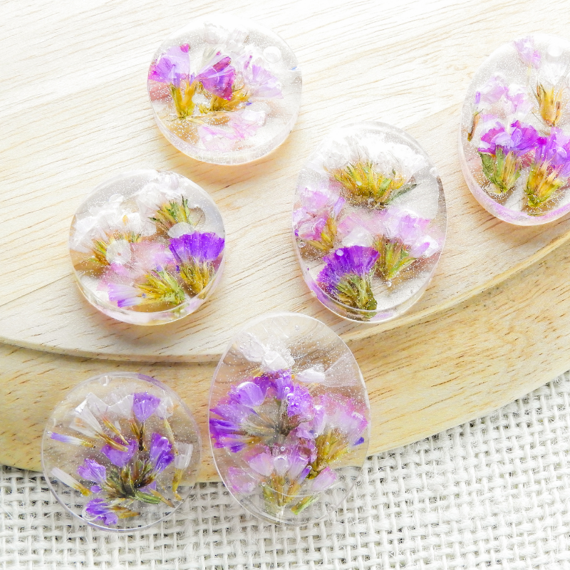 Purple flowers held in resin.