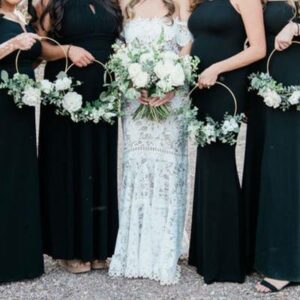bridesmaids - 11 Bridal party holding white flowers.