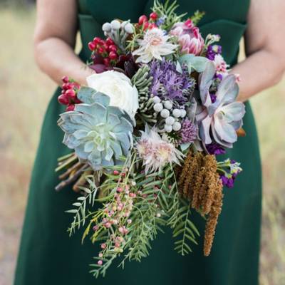 Large bridesmaid's flower arrangement with hanging greenery.