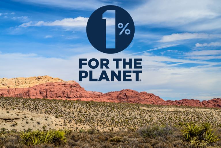 Logo for "1% for The Planet" logo with Las Vegas Red Rock Canyon in the background.