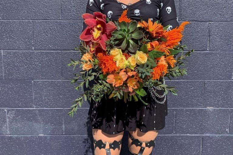 Large wedding flower bouquet in oranges and red with a halloween theme.