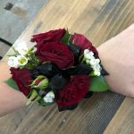 wrist corsage made of red roses.