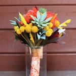 Bridesmaids flower bouquet in yellows and oranges.