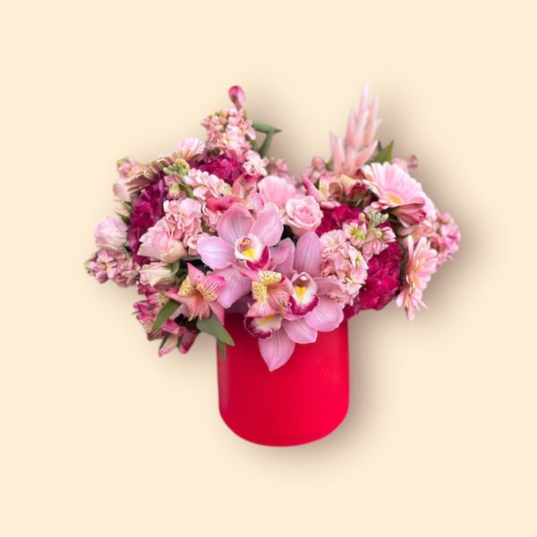 red vase filled with pink flowers