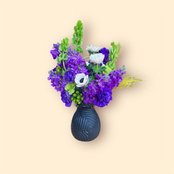 vibrant floral arrangement with deep purples, bright greens, and white anemones