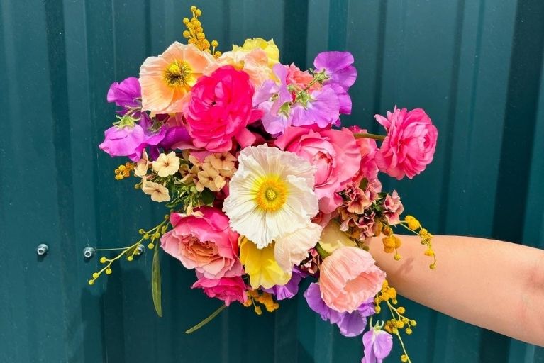 bouquet of flowers including roses, sweet pea, and pansy