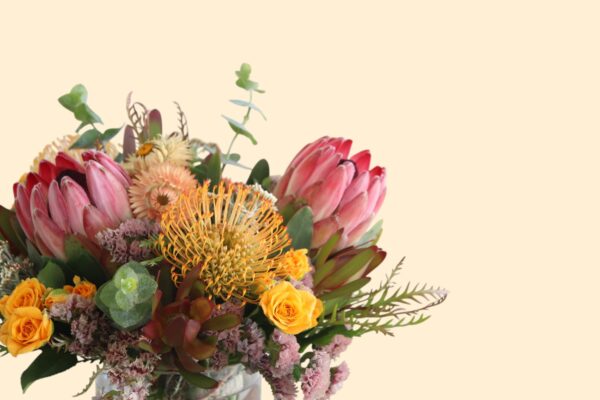 proteas, eucalyptus, and yellow flowers