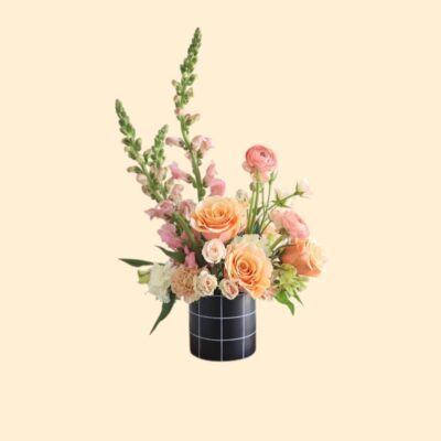 pink flower arrangement with tall flowers in a black vase