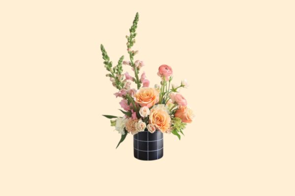 pink flower arrangement with tall flowers in a black vase